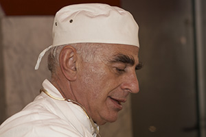 A sausage making Italian butcher shop owner
